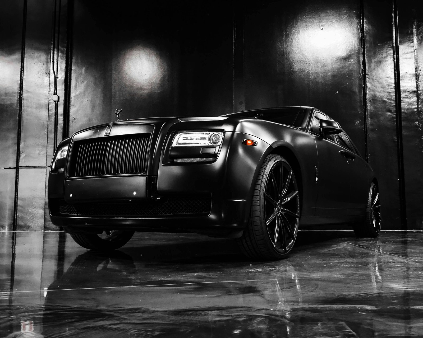 Low angle of modern luxury matte black coupe car parked on marble floor in showroom